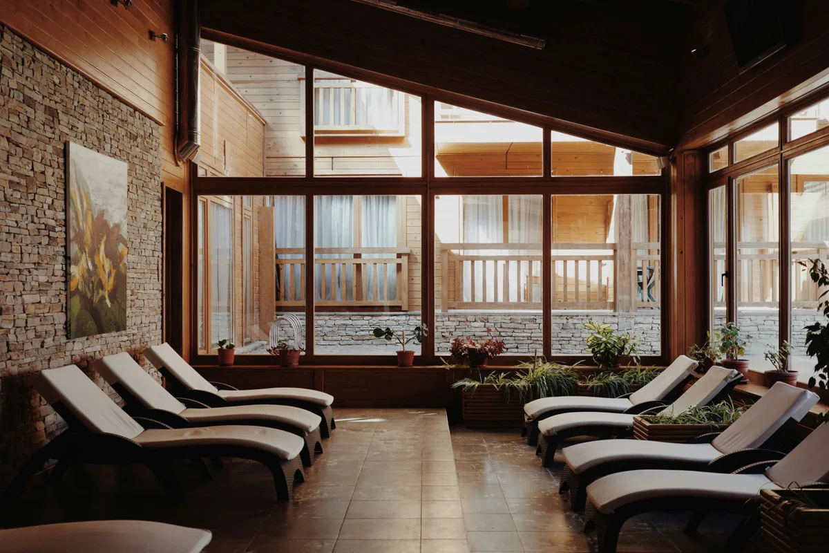 Peaceful resort lounge with natural wood, stone and comfortable loungers